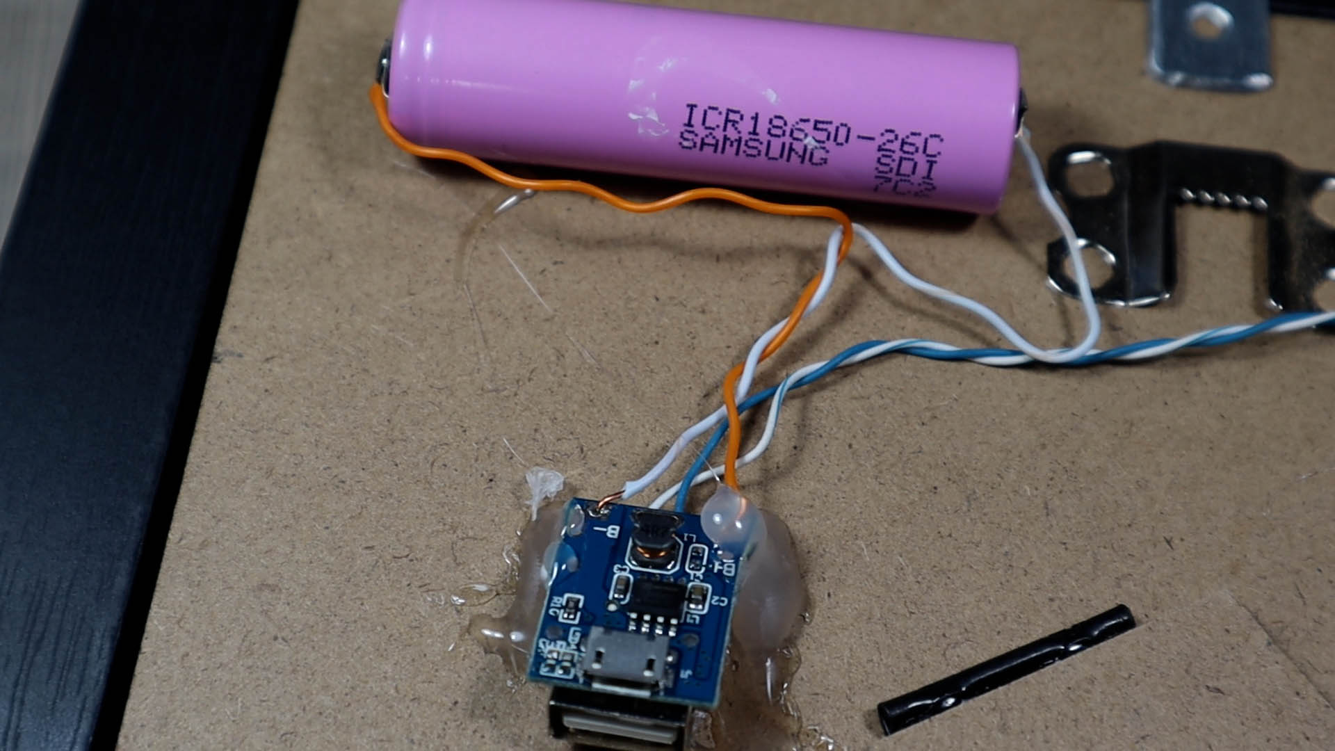 The battery is held by a mess of hot glue